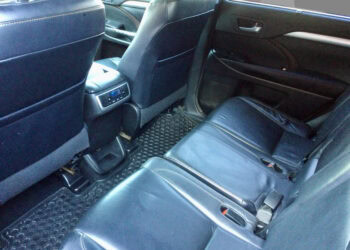 Comfortable black leather rear seats in a 2015 Toyota Highlander XLE hybrid.